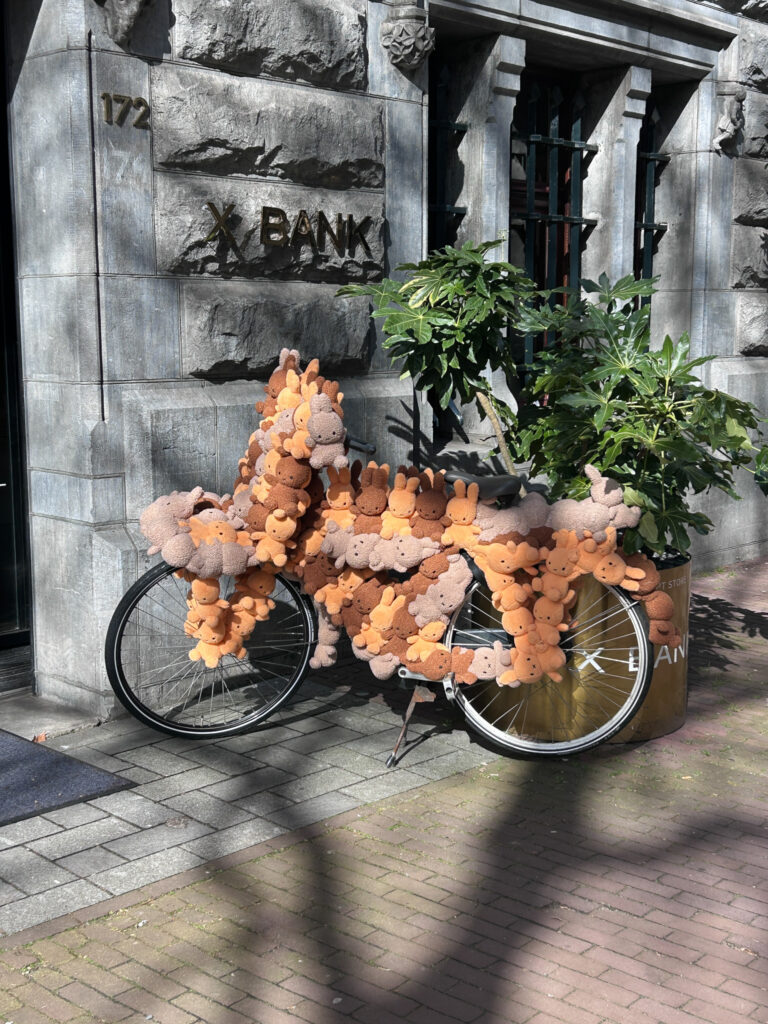 A bicycle decorated with many Miffy plush toys.