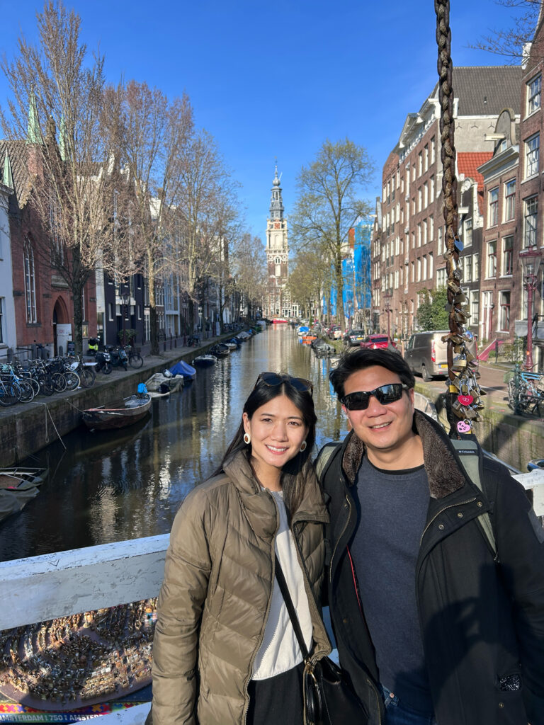 Us on the bridge with one of Amsterdam's canals in the background.